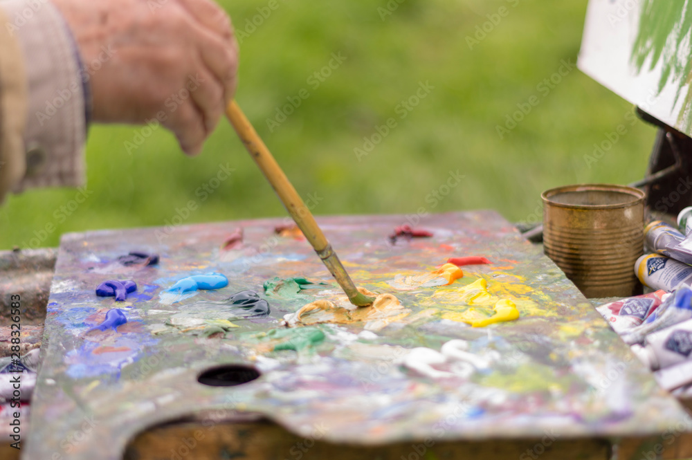 Drawing with oil paints on the nature. Wonderful hobby Drawing with oil paints on the nature. Wonderful hobby