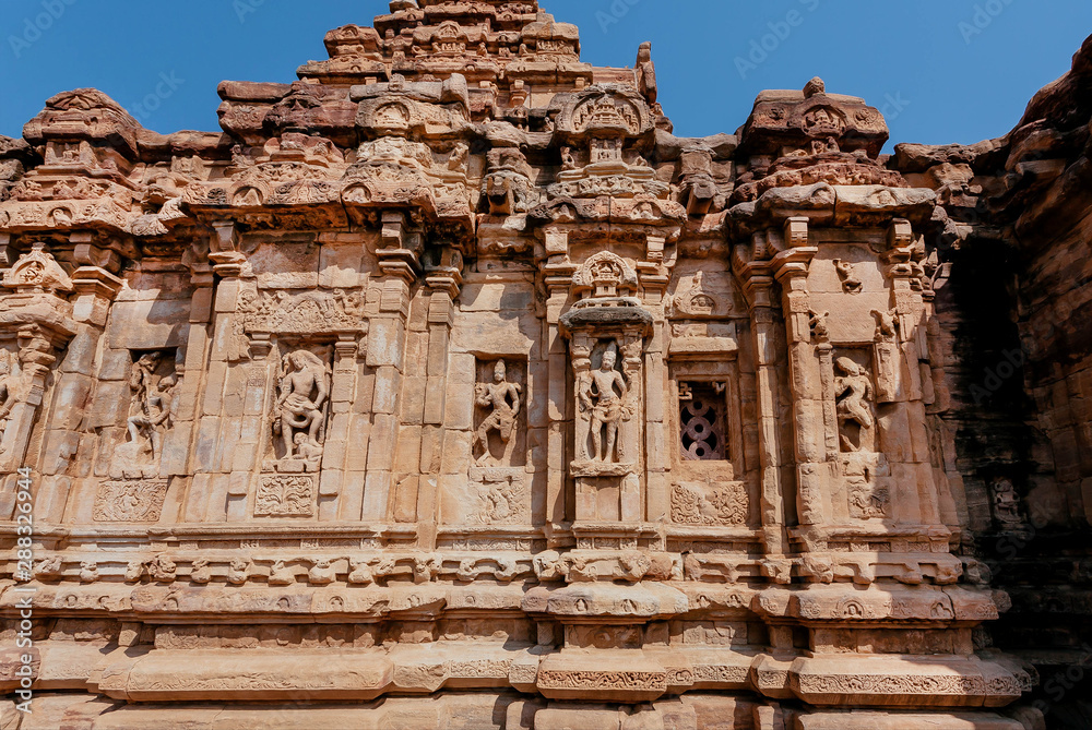 Gods and heroes on facade of the Hindu temple in India. Architecture of 7th century with carved walls in Pattadakal, Karnataka