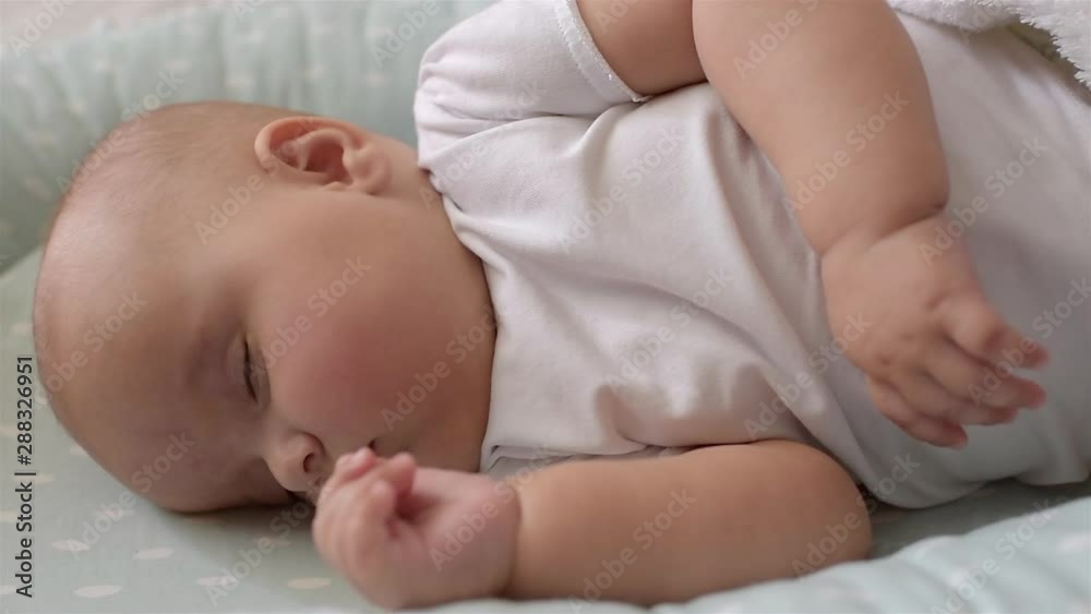 Baby is sleeping on the bed. Close-up. Baby is sleeping on the bed. Close-up.