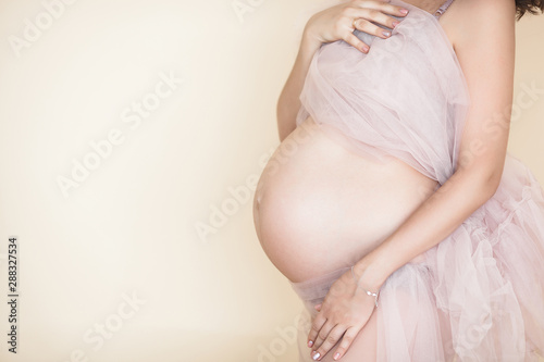 Closeup picture of pegnant woman. Unrecognizable expectant. Belly closeup.