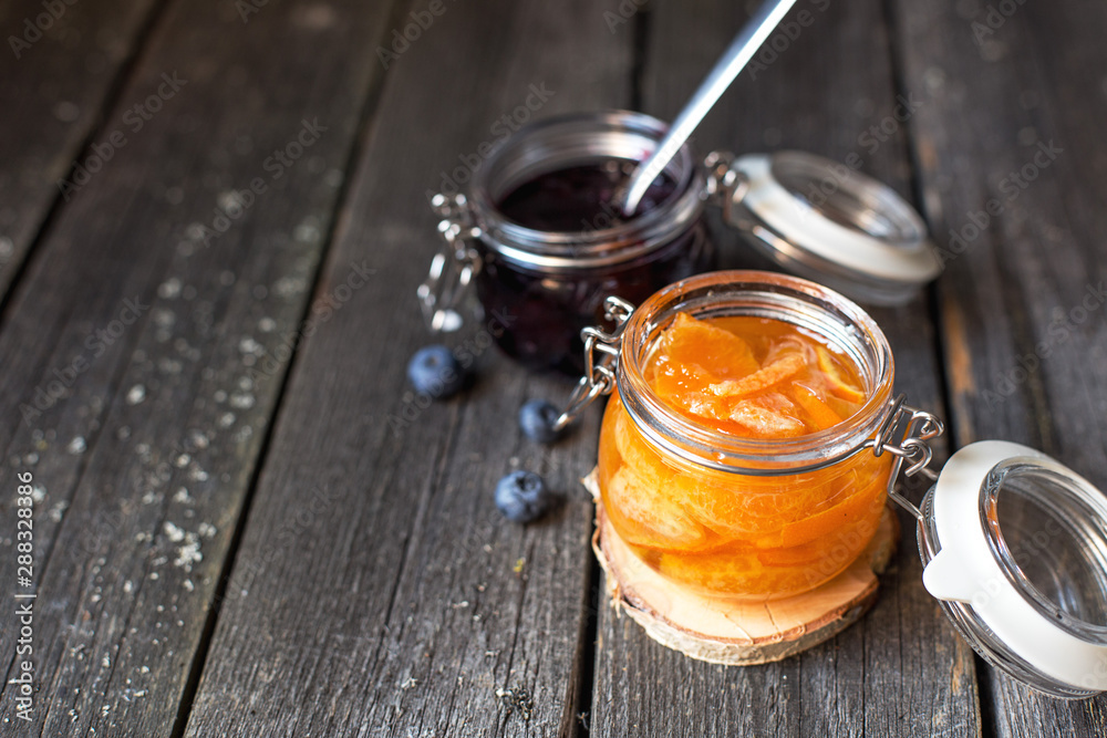 jars of blueberry and tangerine jam on a old wooden background jars of blueberry and tangerine jam on a old wooden background