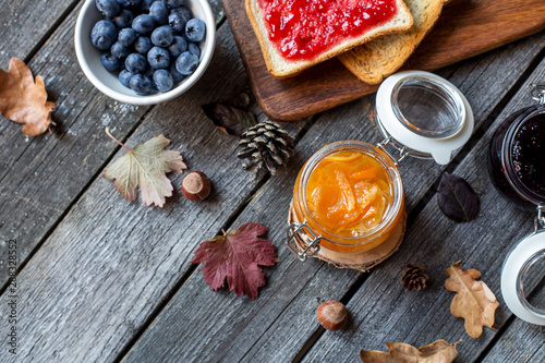 autumn breakfast with toast, blueberry, tangerine jam and decor of leaves