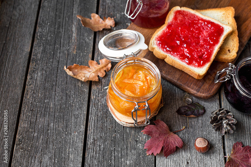 autumn breakfast with toast, blueberry, tangerine jam and decor of leaves
