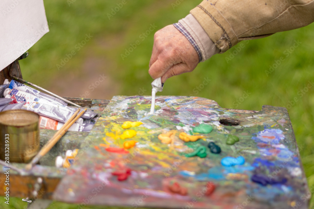 Drawing with oil paints on the nature. Wonderful hobby Drawing with oil paints on the nature. Wonderful hobby