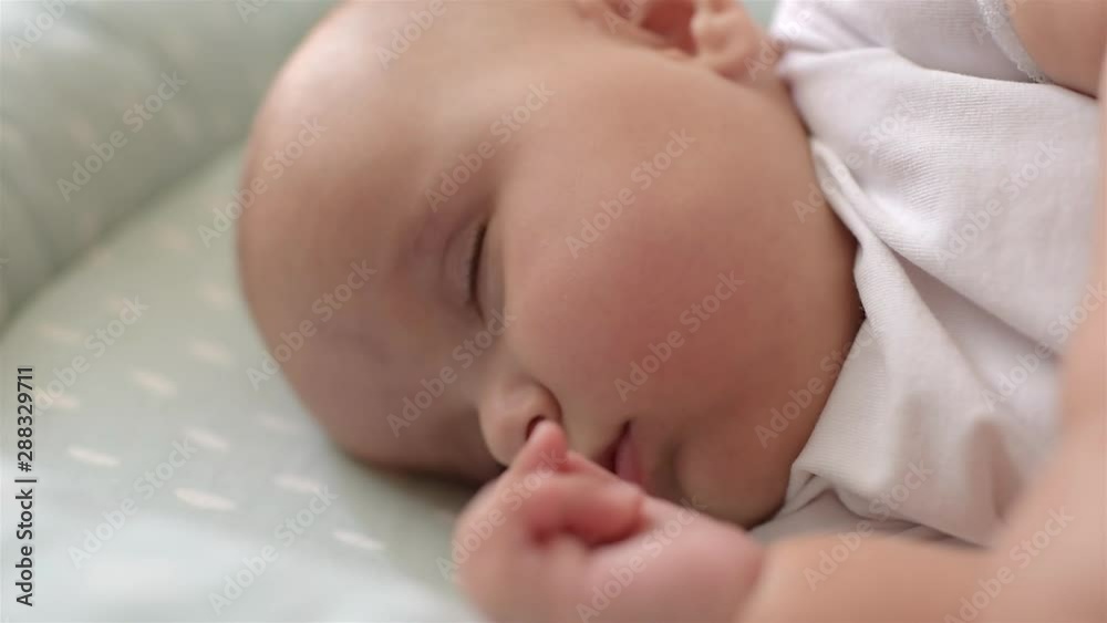 Portrait of cute baby is sleeping on the bed. Close-up. Soft focus. Portrait of cute baby is sleeping on the bed. Close-up. Soft focus.