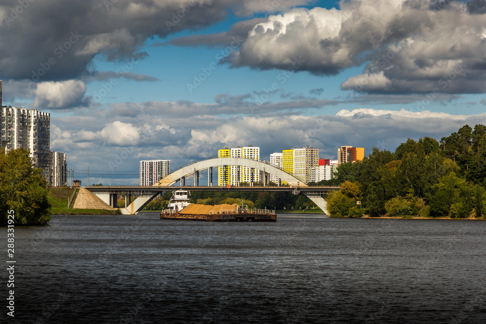 Dry cargo ship on the Moscow Canal river in summer day. Dry cargo ship on the Moscow Canal river in summer day.