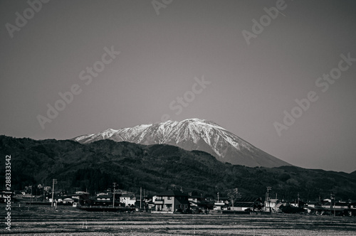 Snow covered Mount Akita Komagatake and local town view from Kakunodate photo