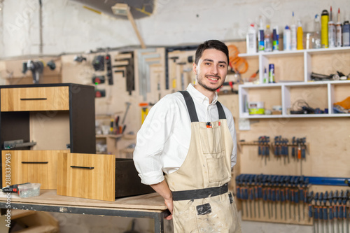 furniture factory, Small-Sized Companies and people concept - Portrait of a smiling male worker at manufacturing