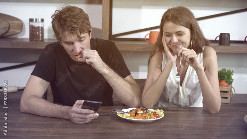 Fighting Caucasian couple smart phone addict problem while eating dinner