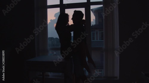 a man and a girl dance, have fun, kiss on a sunset background in the back color