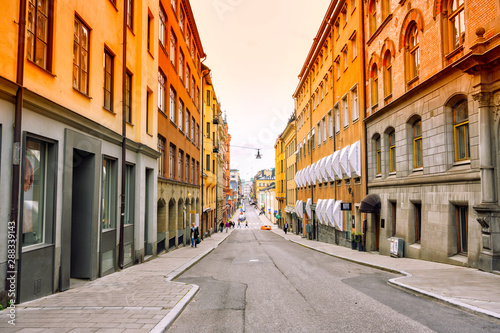 Fototapeta Naklejka Na Ścianę i Meble -  8 July 2019 Stockholm, Sweden. Colourful buildings down town with people walking around in Stockholm