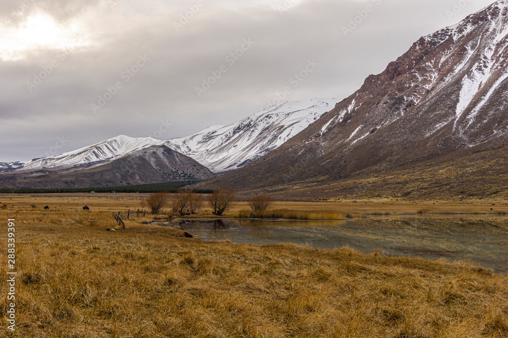 Scene view of an overcast day against snow-capped mountains during winter season in Patagonia, Argentina