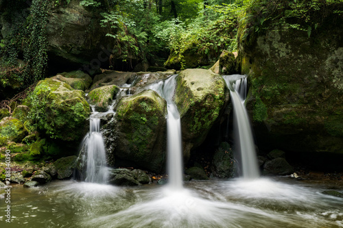 Fototapeta Naklejka Na Ścianę i Meble -  idyllic waterfall in lush green summer forest in Luxembourg