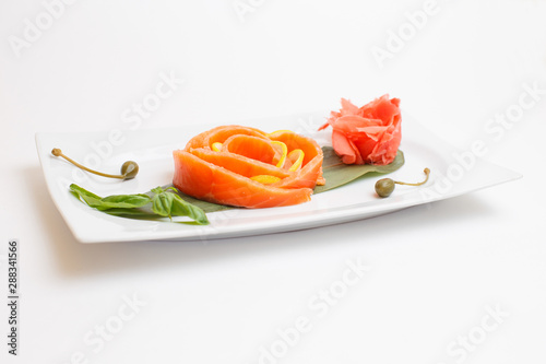 a salmon sushi on white plate