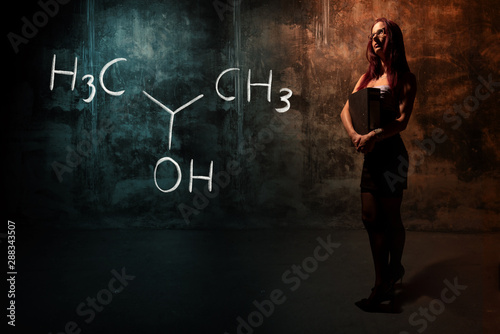 Sexy girl or secretary or female student presenting handdrawn chemical formula of Isopropylalcohol isopropanol 2-propanol photo