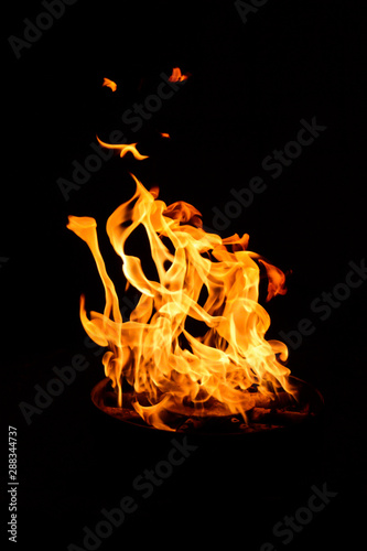Fire flame on a black background. Burning passion, phenomenon of combustion manifested in light, flame and heat. To set on fire. Internal flame. 