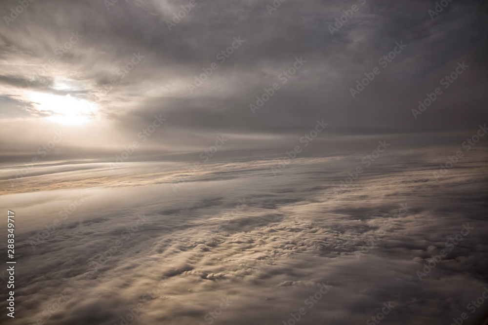 Clouds and sky as seen through window of an aircraft Clouds and sky as seen through window of an aircraft