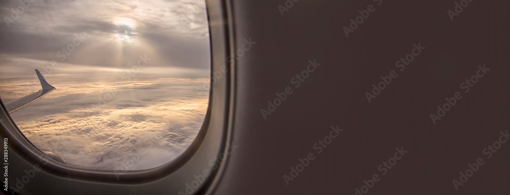 Clouds and sky as seen through window of an aircraft