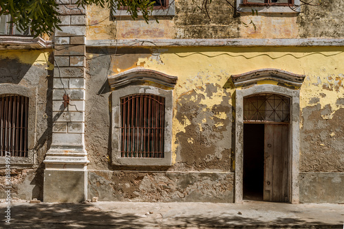 Doors and windows in a weathered, peeling yellow wall on a building in the Island of Mozambique (Ilha de Mocambique) town. Nampula Province, Mozambique, Africa © Jennifer