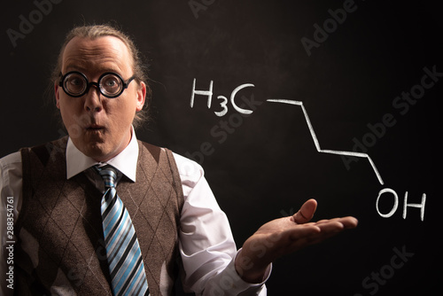 Professor presenting handdrawn chemical formula of n-butanol 1-butanol