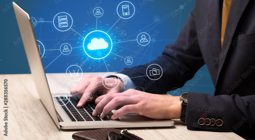 Businessman hand typing with cloud technology system and office symbol concept Businessman hand typing with cloud technology system and office symbol concept
