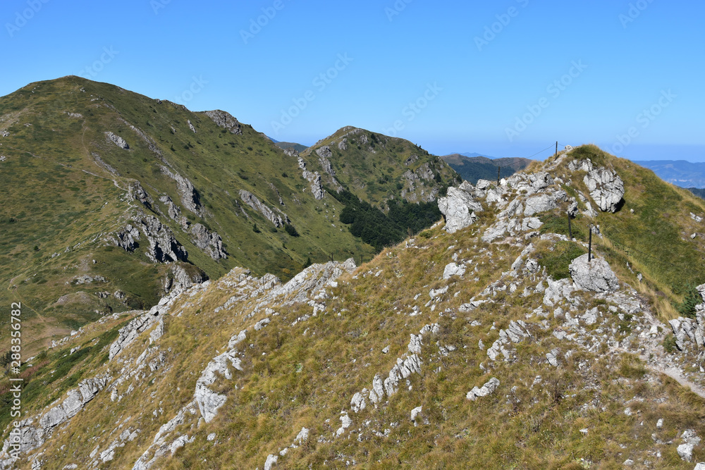 Safety rope on the tourist trail climbing Kozya Stena Peak, Central Stara Planina Mountain ridge, Bulgaria Safety rope on the tourist trail climbing Kozya Stena Peak, Central Stara Planina Mountain ridge, Bulgaria