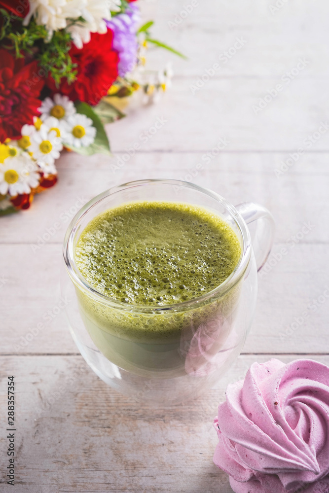 matcha latte, flowers and marshmallow on white background , close-up, copy space matcha latte, flowers and marshmallow on white background , close-up, copy space