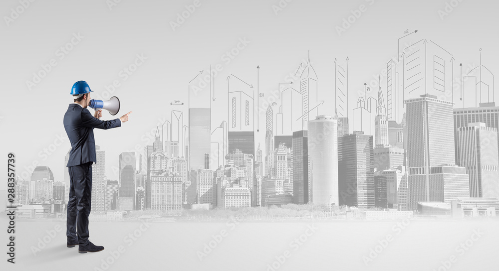 Young supervisor architect standing and replanning a big city panorama Young supervisor architect standing and replanning a big city panorama