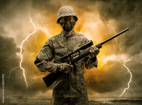 Armed soldier standing in rainy obscure weather