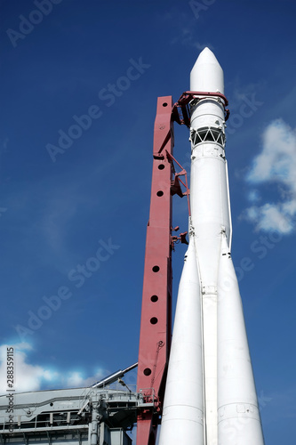 Spaceship on launch pad ready to fly into space vertical photo over blue sky
