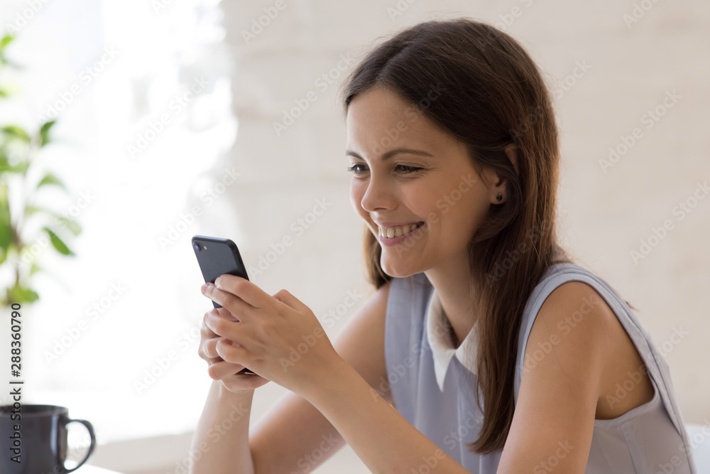 Happy girl feel excited messaging using smartphone Happy girl feel excited messaging using smartphone