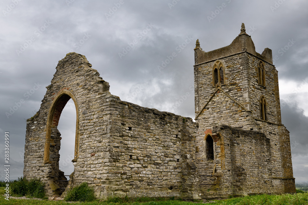 Ruins of St Michael's Church on top of Burrow Mump in Burrowbridge England under cloudy sky
