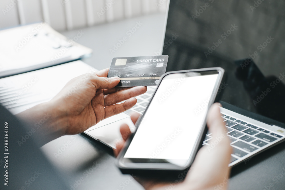 Mockup image of Beautiful woman holding credit card shopping online with laptop on online websites, mockup concept