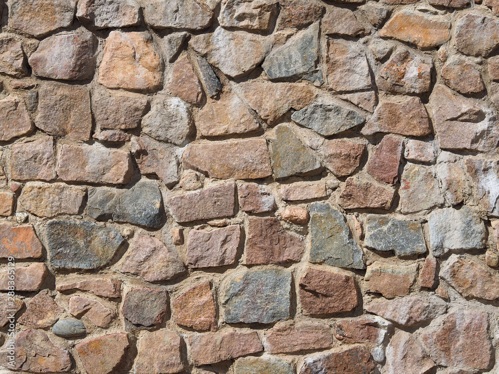 An old wall of different shaped stones. Background and texture. An old wall of different shaped stones. Background and texture.