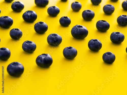 blueberries on a yellow background. summer and vitamins