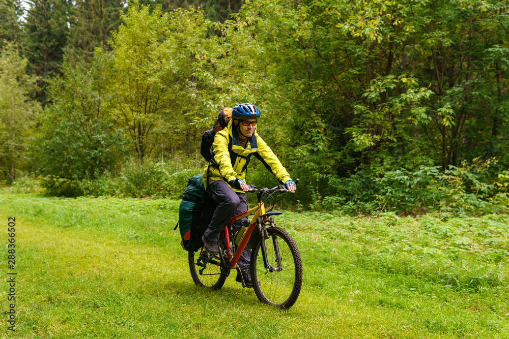 bicycle tourist in the autumn forest