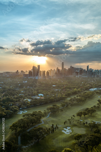 Golf course and Skyline of Manila, Philippines, in a beautiful sunset.