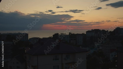 stunning sunset in the city of sochi. window view between houses