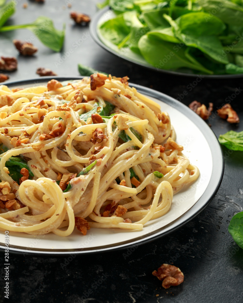Pasta with roasted walnut, ricotta white pesto sauce, parmesan cheese and spinach Pasta with roasted walnut, ricotta white pesto sauce, parmesan cheese and spinach