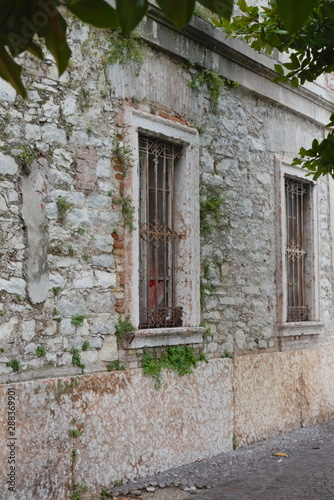 Building made of gray stone and bars on the windows