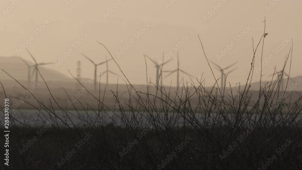 The rotary movement of wind turbines during a cloudy afternoon at sunset. The rotary movement of wind turbines during a cloudy afternoon at sunset.