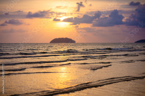 Fototapeta Naklejka Na Ścianę i Meble -  Sunset at tropical beach. Ocean waves by sunrise.