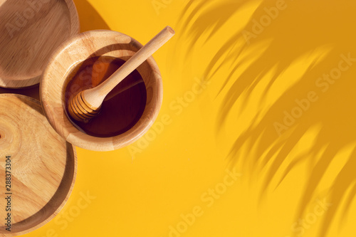 honey with wood dish cup in kitchen on yellow background organic natural, fresh food drink, summer season photo