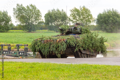 German army infantry fighting vehicle  drives on tactical exercise at military training area photo