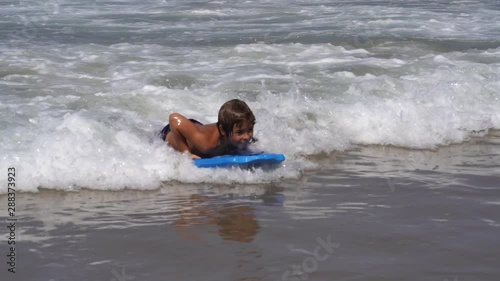 Young children bodyboarding in the Atlantic ocean