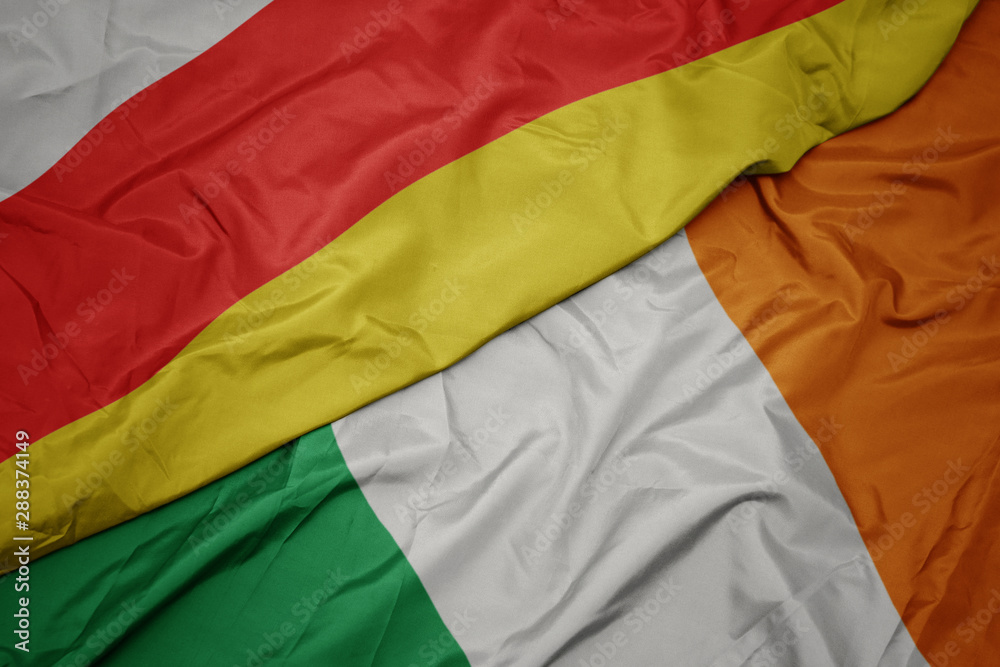 waving colorful flag of ireland and national flag of south ossetia. waving colorful flag of ireland and national flag of south ossetia.
