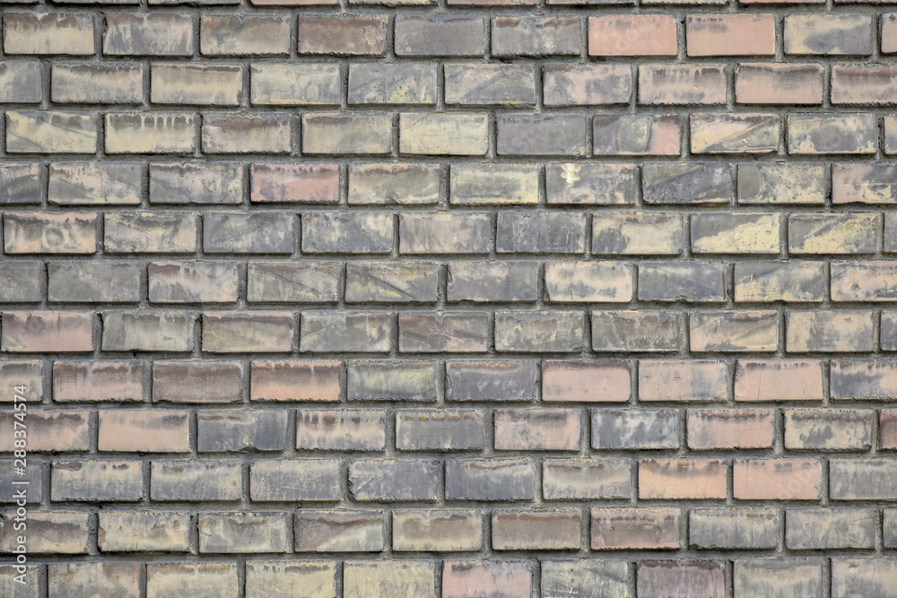 Fragment of an old brick wall. The texture of the brickwork of different colors. Copy space.