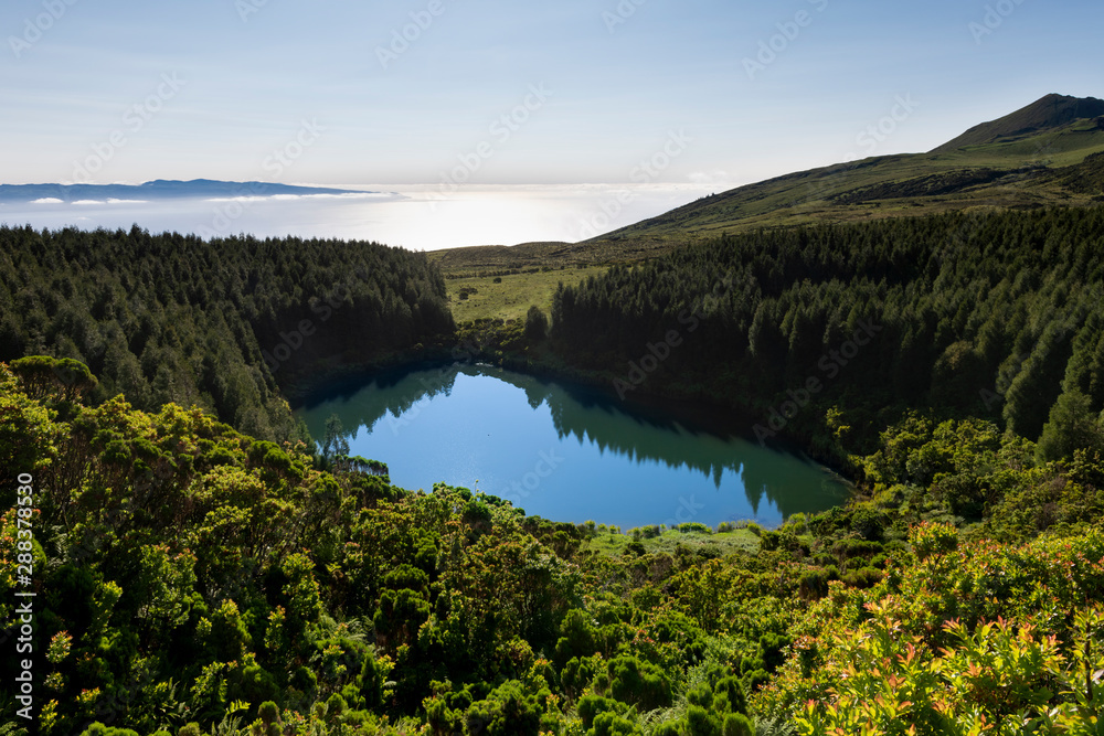 Volcanic crater with lake Lagoa Seca on Pico island short after sunrise.