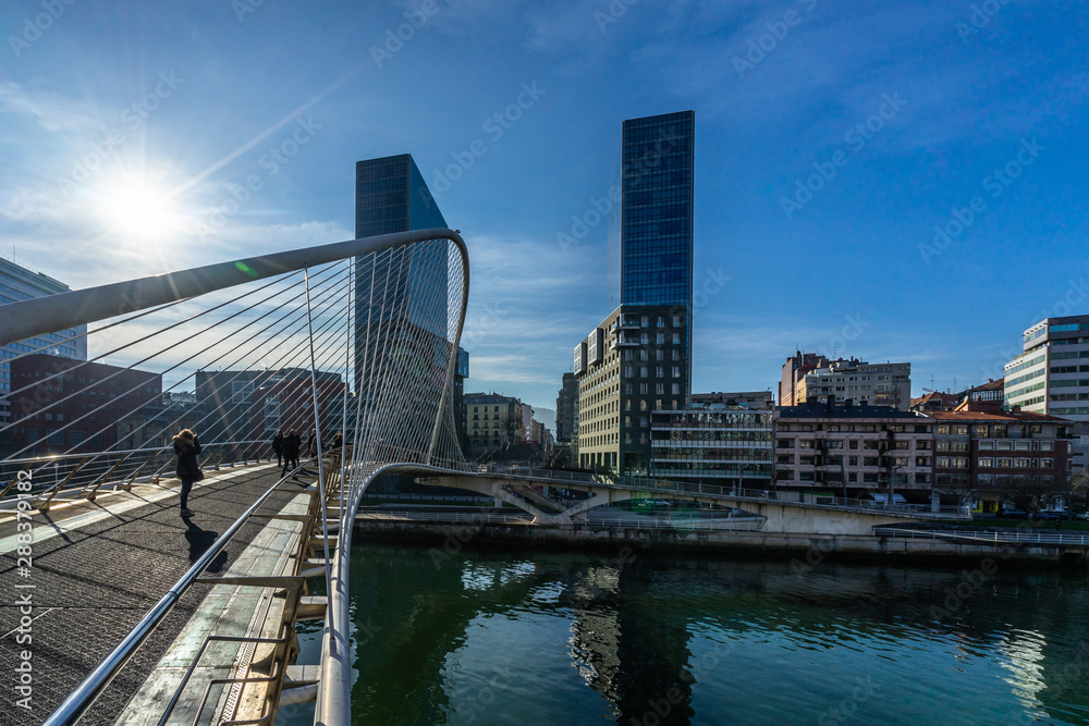 Zubizuri footbridge and Isozaki Atea skyscraper in Bilbao, Basque Country, Spain