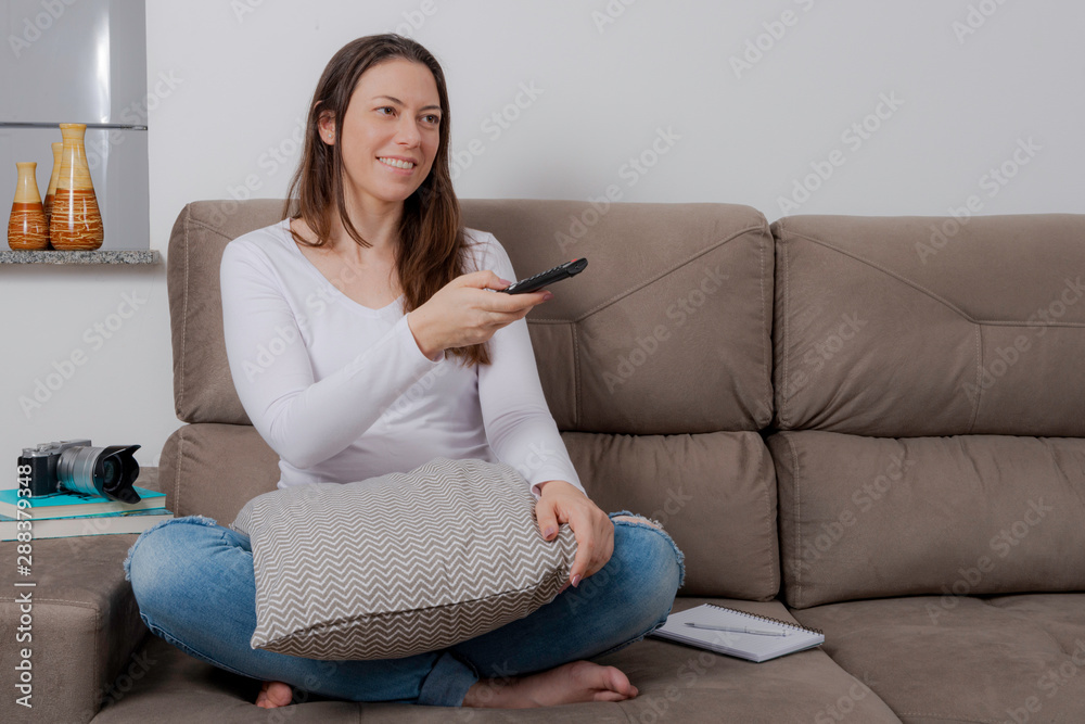Beautiful Woman Watching Television. Changing channels. Beautiful Woman Watching Television. Changing channels.
